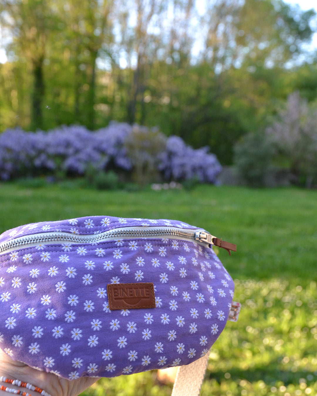 Dans cette image en gros plan, les détails élégants de la Binette Marguerite Violette sont mis en avant. Chaque pétale de la marguerite semble prendre vie, créant un motif dynamique et captivant. La teinte violette douce et apaisante ajoute une touche de sophistication à l'ensemble, parfaitement adaptée à la saison estivale. Cette photo capture la beauté intemporelle de la Binette Marguerite Violette, en faisant un accessoire essentiel pour toutes les fashionistas estivales.